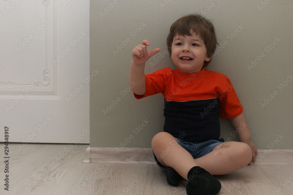 Young kid playing on a floor in a room Young kid playing on a floor in a room