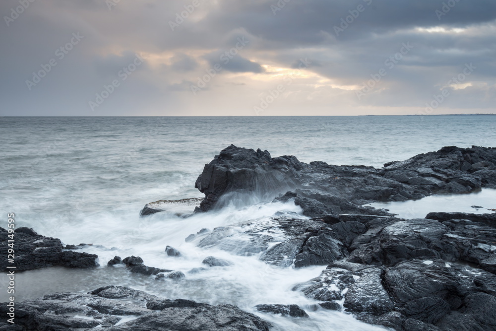 Ocean during a storm with seagulls and rocky horizon