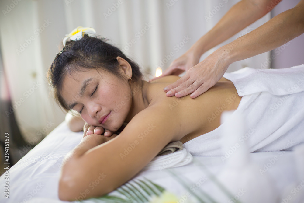 An Asian woman is massaging a herbal spa with a relaxing, happy feeling. An Asian woman is massaging a herbal spa with a relaxing, happy feeling.