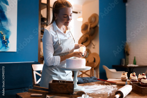 young talented cook using pastry bag while cooking cake.free time, spare time, lifestyle