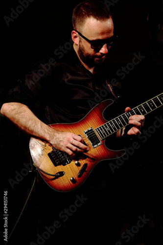 young man playing electric guitar
