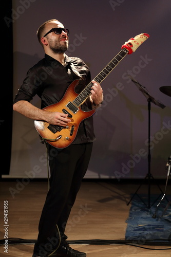 young man playing electric guitar