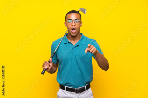 African American golfer player man surprised and pointing front