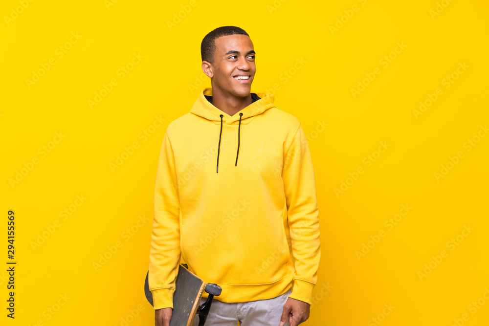 African American skater man looking up while smiling African American skater man looking up while smiling