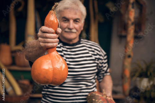Man holding pumpkins outdoors