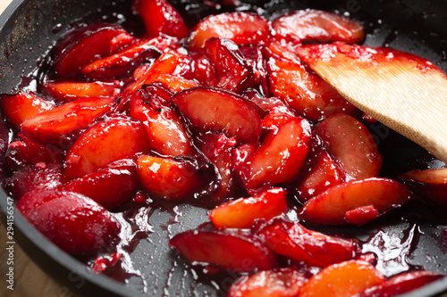 cooking fresh plums in a pan