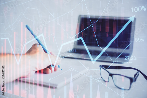 Multi exposure of man hands with stock market forex graph.