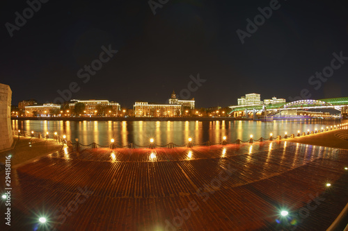 Night cityscape in wet autumn night. Main Building of the Ministry Defense in Moscow / Minoboron in distance, Moskva River, pedestrian Andreevsky / Pushkin bridge. Long exposure photography © Yury and Tanya