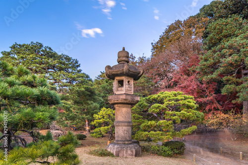Stone Kasuga lantern in autumn in the Rikugien Park of Bunkyo district, north of Tokyo. photo