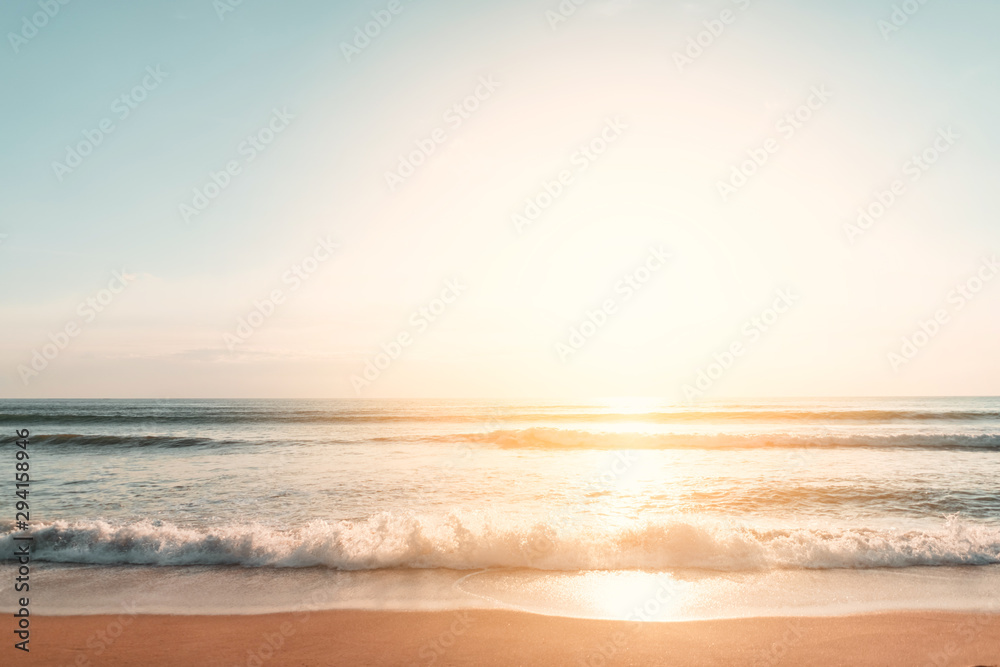 Tropical beach with smooth wave and sunset sky abstract background. - obrazy, fototapety, plakaty 