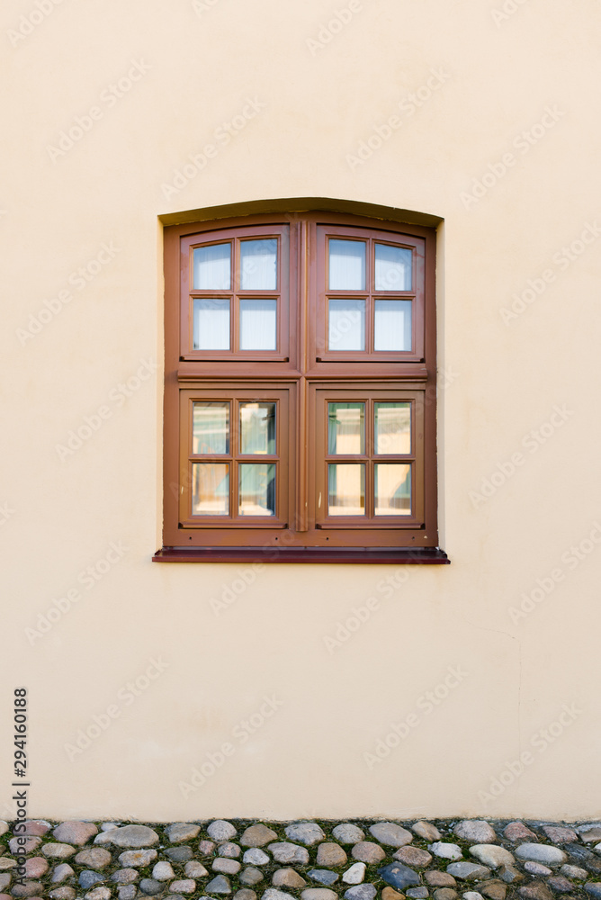 Brown wood window in a beige house