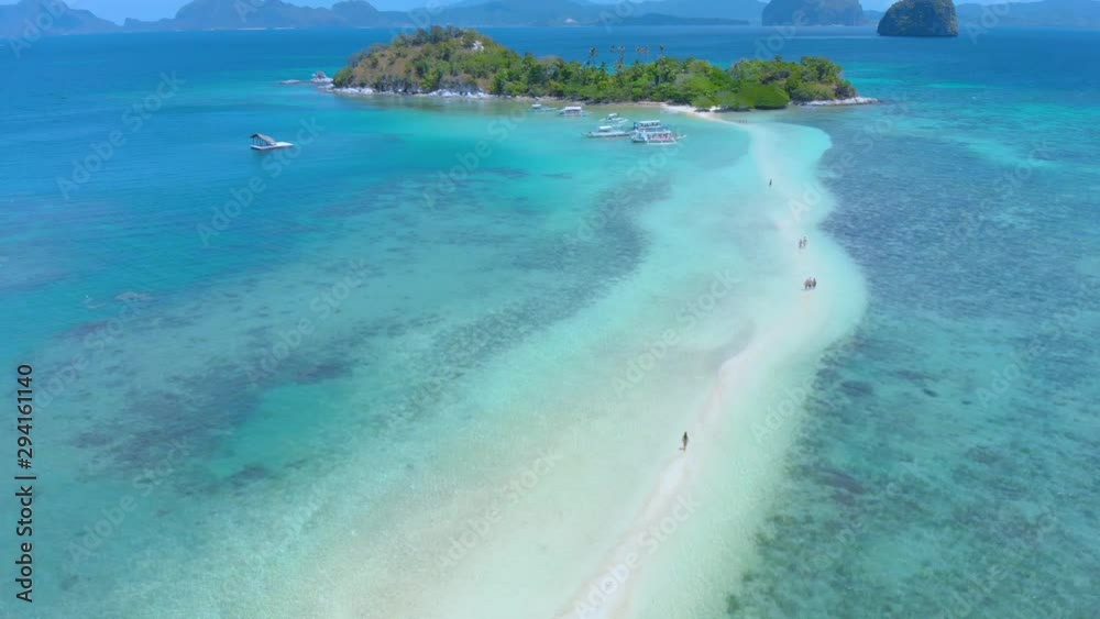 Aerial landsape of Snake Island, fly over travel couple on the Sandbar and lagoon with turquoise  water. El Nido, Palawan. Philippines.