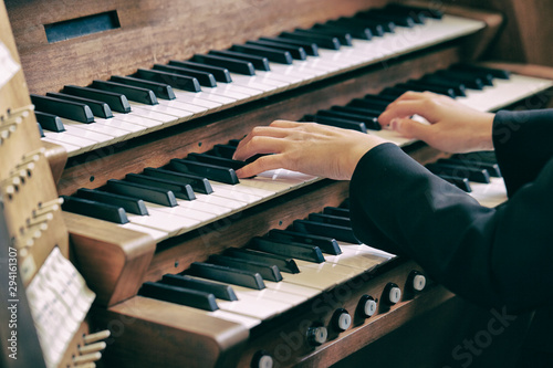 A woman playing the pipe organ 