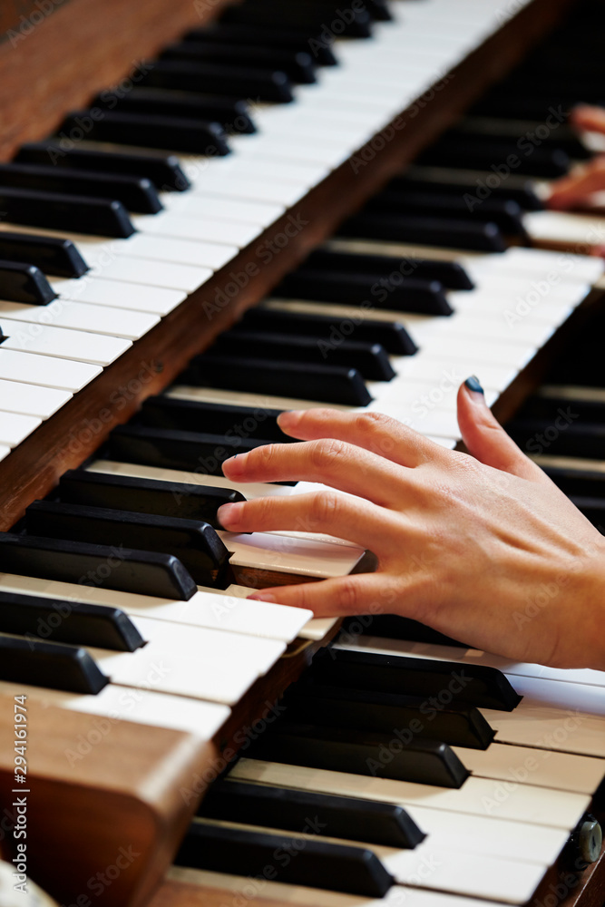 Fototapeta premium A woman playing the pipe organ 