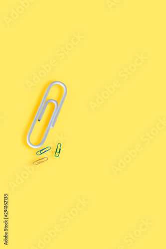 Flat lay minimal clip paper on yellow background © chayanit