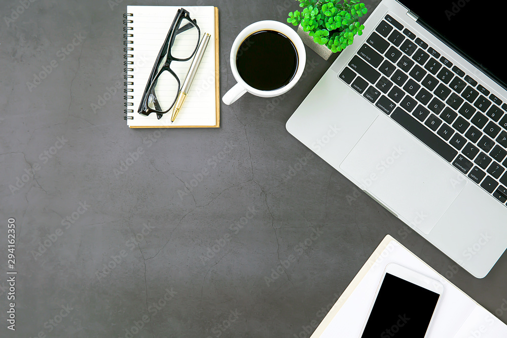 Fototapeta premium Top view desk ,Modern office desk Workspace with laptop computer, coffee cup, glasses,notebook and office supplies for Working background concept.