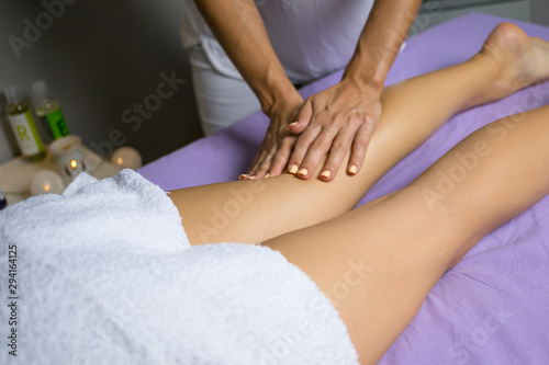 Female relaxing leg massage with hands. Beauty body skin care treatment concept.