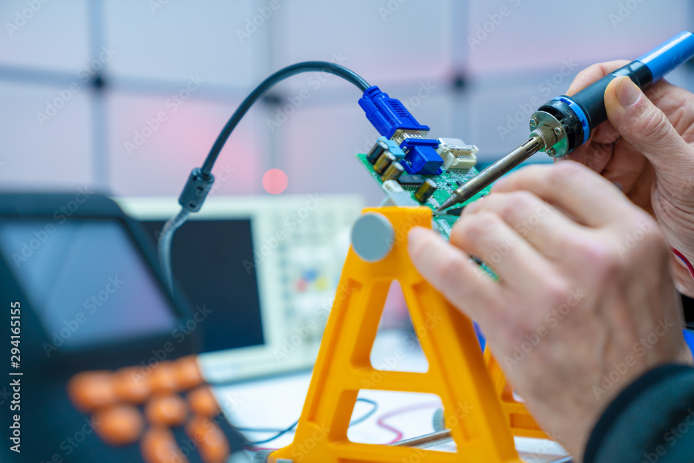 Fixing electronics PCB board in service / workbench with electronics measuring instruments Fixing electronics PCB board in service / workbench with electronics measuring instruments