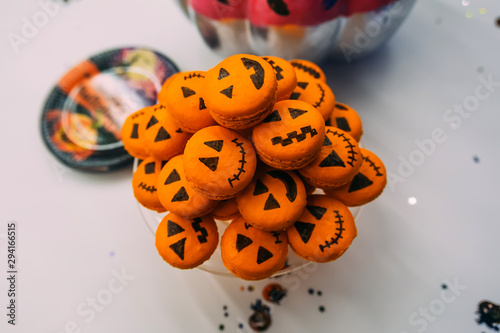 Fresh halloween pumpkin cookies on white table