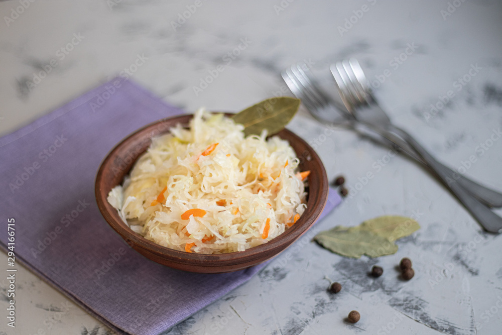 Plate with sour cabbage. This is a useful fermented product. Sour cabbage is rich in vitamins and is used in many dishes of different nations. The fermentation process does not destroy nutrients. Plate with sour cabbage. This is a useful fermented product. Sour cabbage is rich in vitamins and is used in many dishes of different nations. The fermentation process does not destroy nutrients.