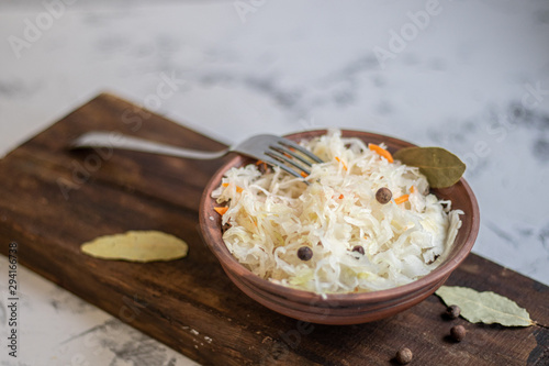 Plate with sour cabbage.  This is a useful fermented product.  Sour cabbage is rich in vitamins and is used in many dishes of different nations.  The fermentation process does not destroy nutrients.  