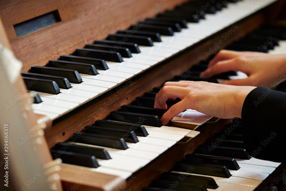 Fototapeta premium A woman playing the pipe organ 