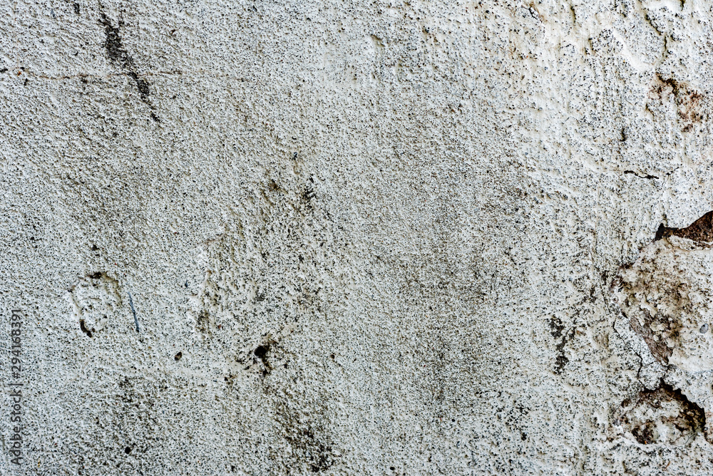 Texture of a concrete wall with cracks and scratches which can be used as a background Texture of a concrete wall with cracks and scratches which can be used as a background