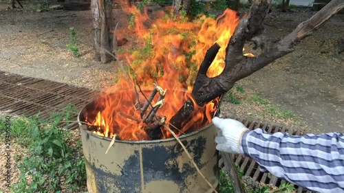 Dry twigs burned by flames Put in a large oil tank To make charcoal Destroying air pollution Global warming Adversely affecting the atmosphere in the future and now photo