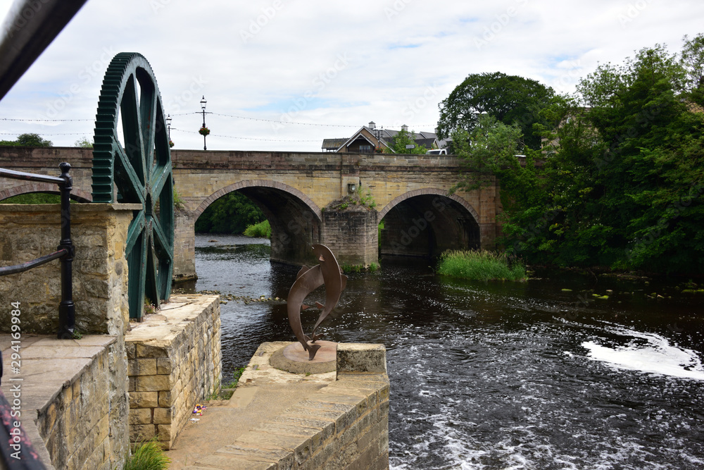 Fototapeta premium Leaping Salmon Motif on the River Wharfe Wier at Wetherby Bridge, Yorkshire