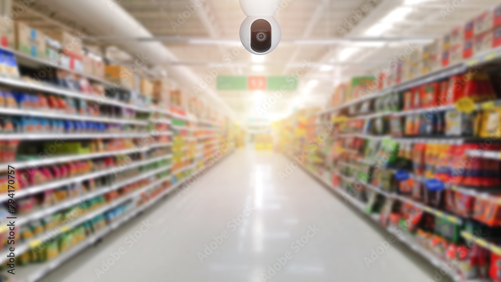 The CCTV Security Camera operating in supermarket store blur background. Business protection.
