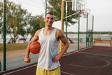 Muscular basketball player on outdoor court