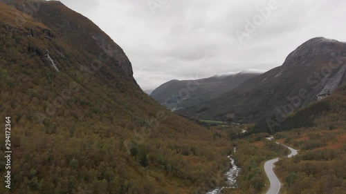 Aerial shot of a road and small stream in the mountain valley at Eresfjord, Norway. photo