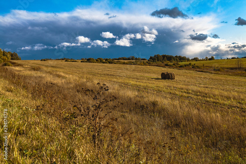 Autumn landscape - a mown field against a picturesque cloudy sky
