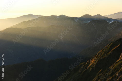 北アルプス　槍穂高大キレット縦走　南岳山頂からの風景　夕陽の光芒と笠ヶ岳のシルエット © DONDON2018