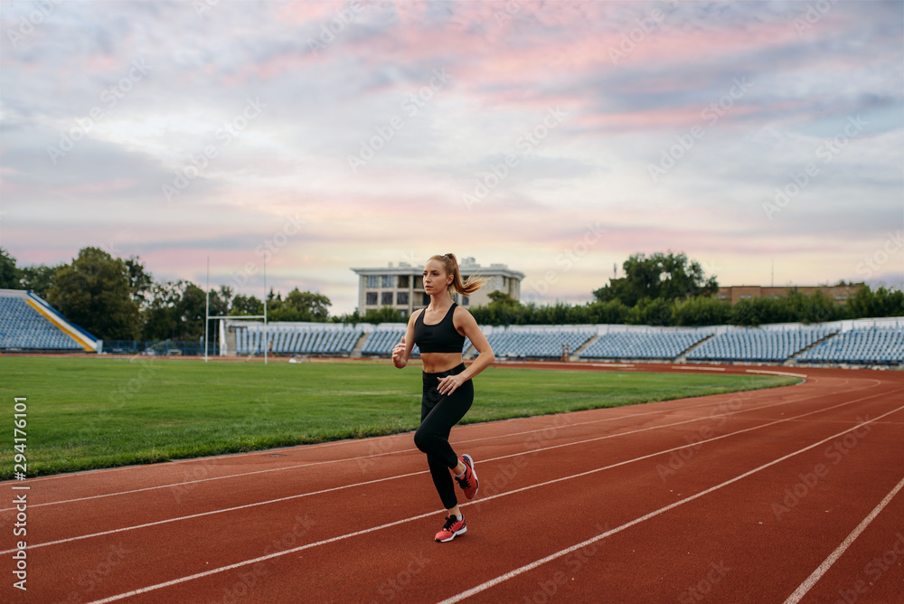 Fototapeta premium Female runner jogging, training on stadium