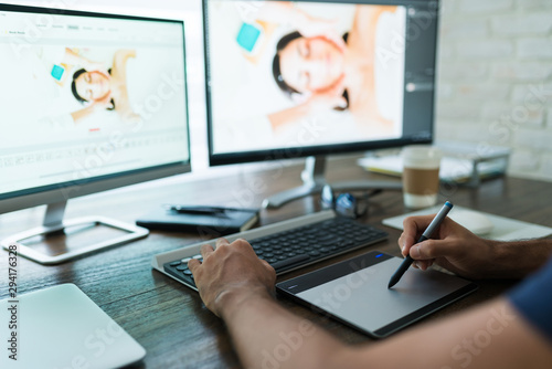 Young Male Retoucher Working At Desk