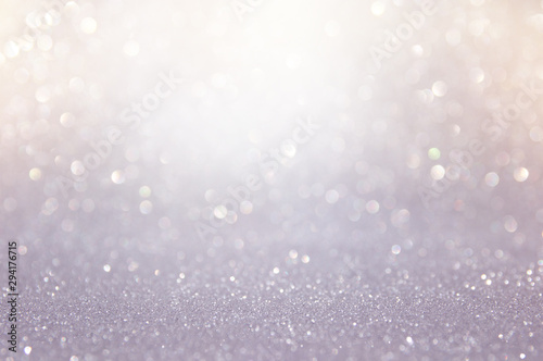 abstract backgrounf of glitter vintage lights . silver and white. de-focused