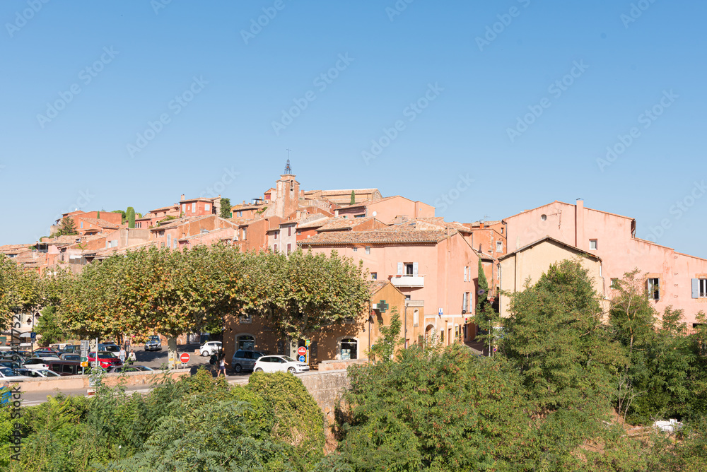 View of hilltop medieval ochre village of Roussillon, one of the most beautiful villages of France in a sunny summer day.