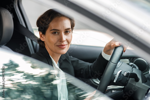 Canvas Side view of businesswoman driving car looking out of window