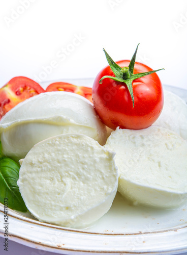 Italian soft cheese mozzarella, white cheese made from cow or buffalo milk with fresh green basil herb and red tomato