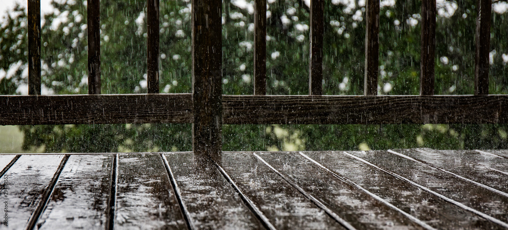 Pouring rain splashing on a deck. Pouring rain splashing on a deck.