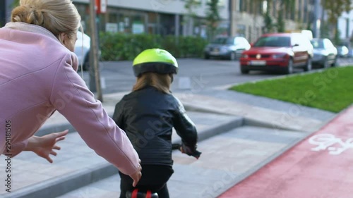 Wallpaper Mural Loving mother helping daughter learning to ride bicycle outdoors, connection Torontodigital.ca