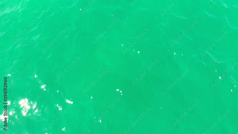 Aerial drone birdseye view shot of water surface of ocean sea, crystal clear see through turquoise waves, relaxed and chill vacation holiday deserved time Aerial drone birdseye view shot of water surface of ocean sea, crystal clear see through turquoise waves, relaxed and chill vacation holiday deserved time