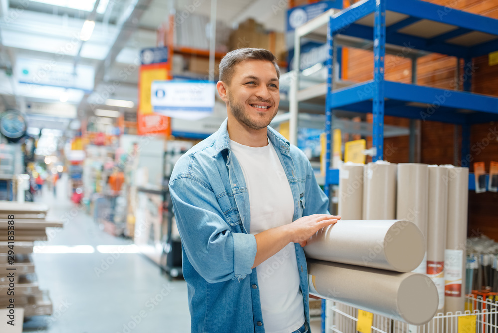 Fototapeta premium Male consumer buying wallpapers in hardware store