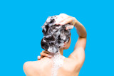 Girl washing her head on a blue background