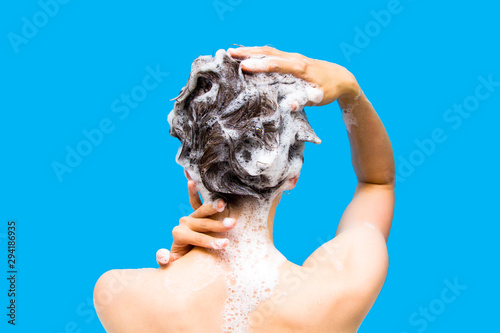 Girl washing her head on a blue background