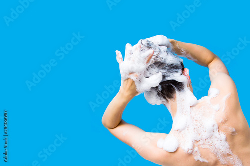Girl washing her head on a blue background