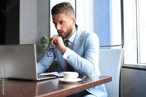 Modern businessman thinking about something while sitting in the office
