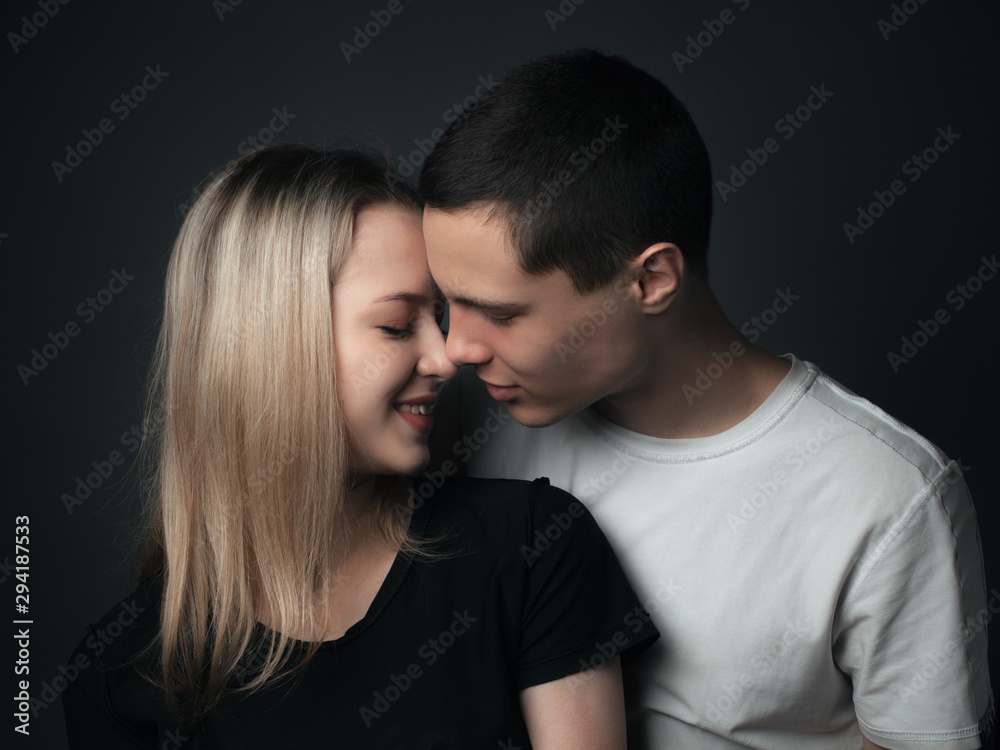 Young couple kissing in studio. Young couple kissing in studio.