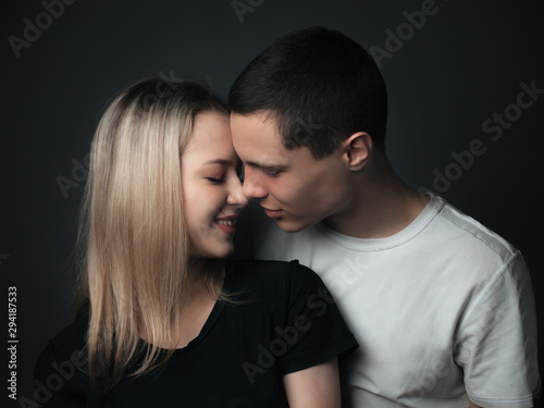 Young couple kissing in studio.